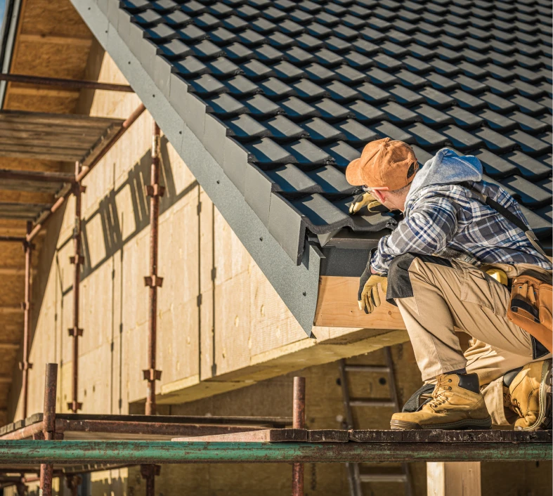 Roofer inspecting newly installed roof tiles