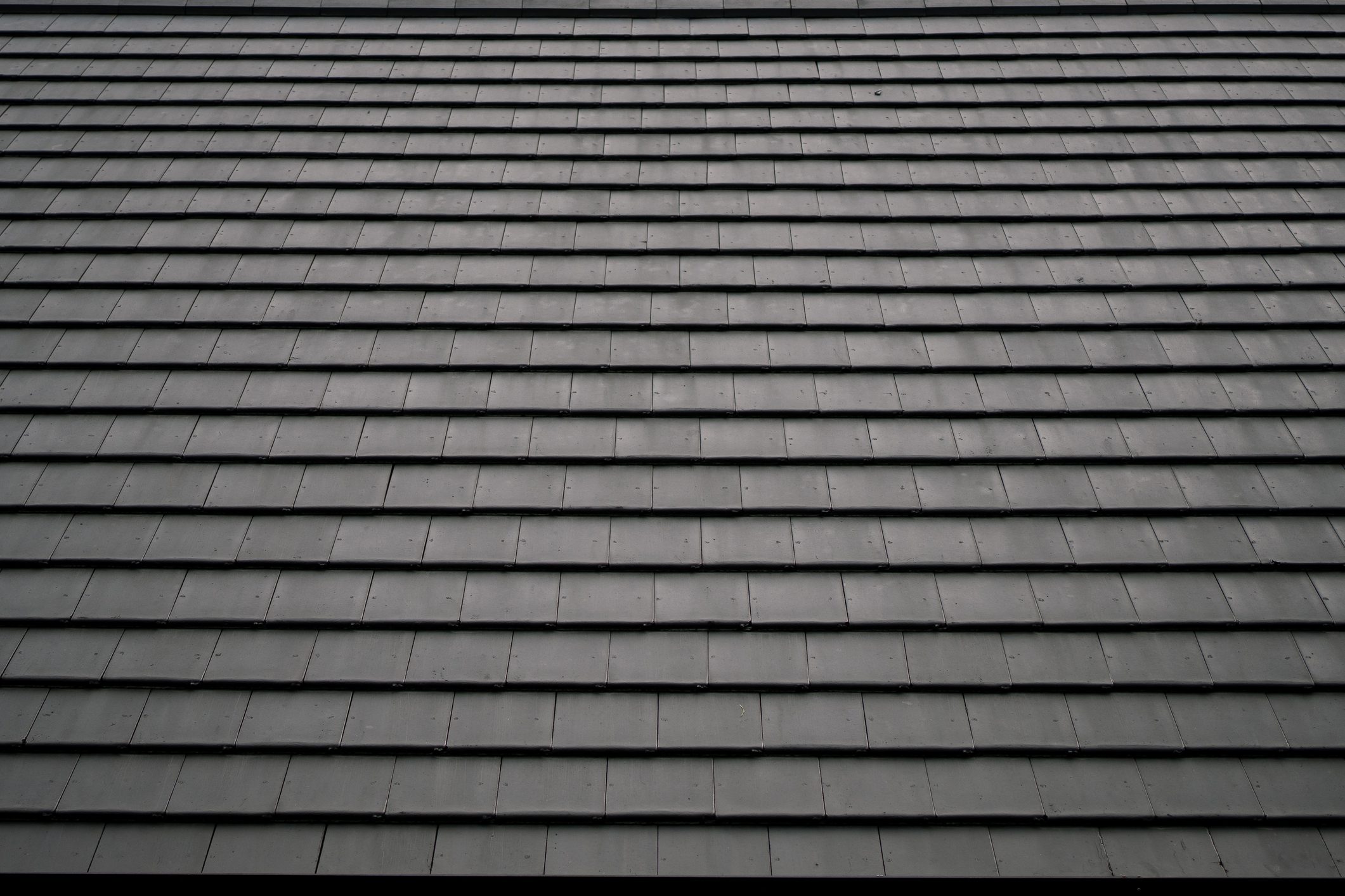 Pattern of black square-shaped roof tiles. Abstract