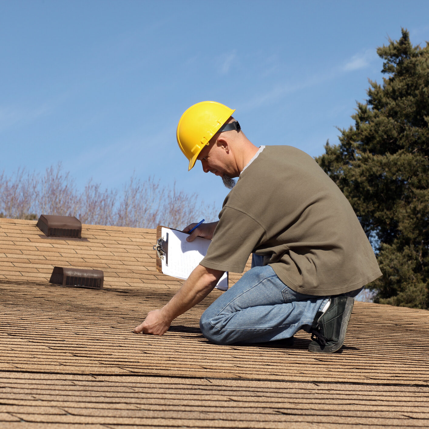 Inspector checking on the condition of a home owners roof.